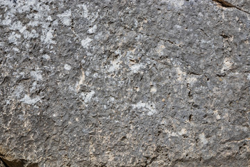 The ancient megalithic walls surround the acropolis of Amelia, in Umbria, Italy. Texture composed of huge blocks of stone, with irregular boulders interlocked together.