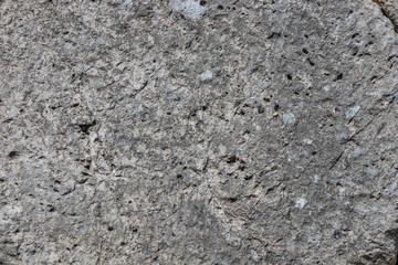 The ancient megalithic walls surround the acropolis of Amelia, in Umbria, Italy. Texture composed of huge blocks of stone, with irregular boulders interlocked together.