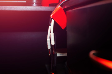 Music tuner. Record sound, music. Making music, recording. Creating sound foundations. Digital sound converter on a red background in the recording room.