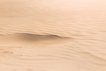 Wind made sand pattern in beach.