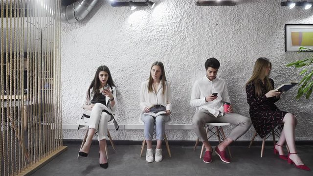 Jobless applicants group sitting in queue waiting for job interview