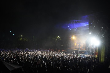 Kiev, Ukraine, Europe - September 15, 2019: Many spectators in front of the stage waving their hands. Open air music festival "SolomaFest". Fans dance in front of the stage at the concert.