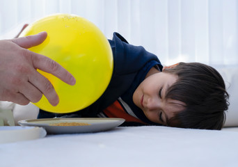 Father and son doing science project, experiment with gelatine and static charged balloon,Man...