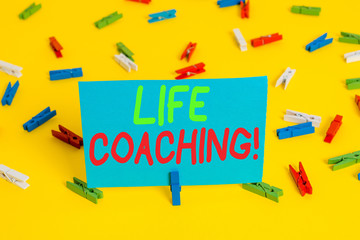 Writing note showing Life Coaching. Business concept for demonstrating employed to help showing attain their goals in career Colored clothespin papers empty reminder yellow floor background office
