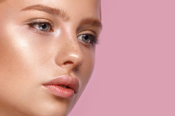 Beautiful girl with classic make-up on a bright background. Beauty face.