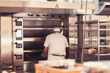 Man baking bread in the bakery