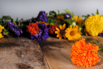 Bouquet with multicolor flowers on a wooden table