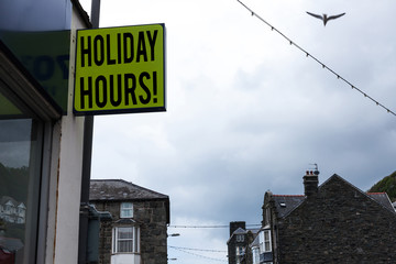 Obraz premium Writing note showing Holiday Hours. Business concept for Overtime work on for employees under flexible work schedules Green ad board on the street with copy space for advertisement