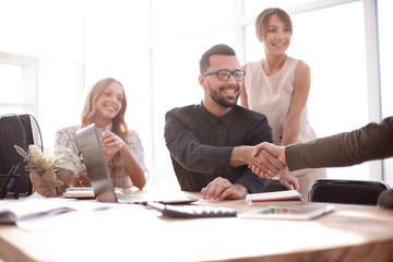 Fototapeta premium background image of the handshake of business partners in the office