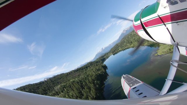 airplane in flight over a lake