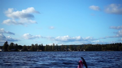 Three gees swarms starting to fly from the lake - far and many, close and a few and finally bigger amount flying from the right to left very close to people in kayak!