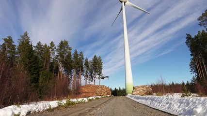 A drone flying up to conduct regular technical control of windmill, fly around to make close up video for further evaluation by technicians