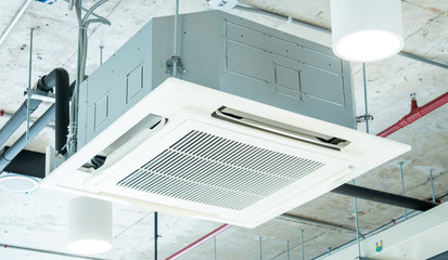 Modern ceiling air conditioning system in loft office, cassette type