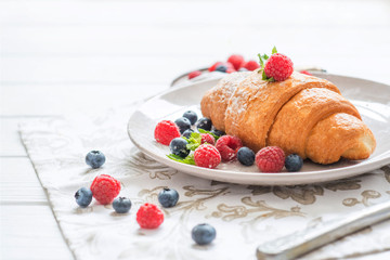 breakfast croissant with berries blueberries and raspberries