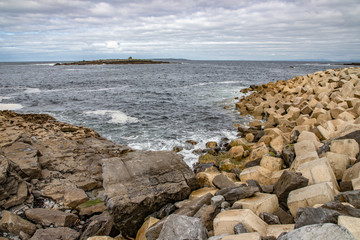 Fototapeta na wymiar Harbour beach with waves and Crab Island in background