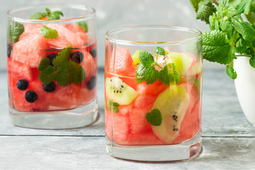 Watermelon and  kiwi drink in glasses with mint. Ice cold summer cocktail or lemonade in glass.