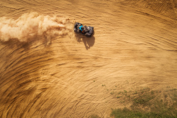 Aerial view of Quad bikes driving in the sand . © valdisskudre