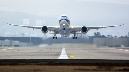 Airplane taking off from an airport, with heat from the engines visible