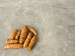 Group of curcuma roots on gray. Selective focus.