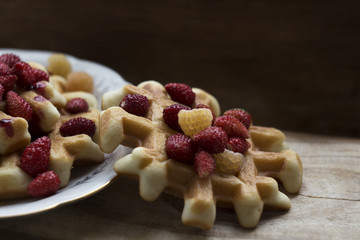 Homemade waffles with berries  wooden background. Delicious, nutritious, fantastic breakfast or dessert