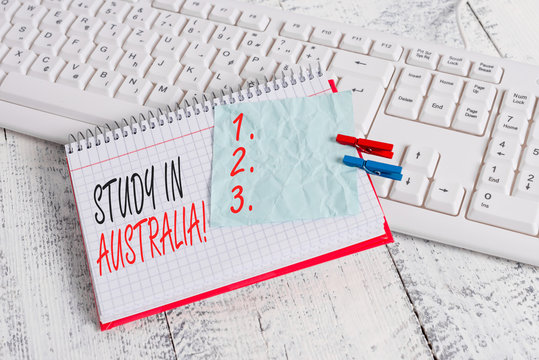 Text sign showing Study In Australia. Business photo showcasing going into foreign country order complete your studies notebook paper reminder clothespin pinned sheet white keyboard light wooden