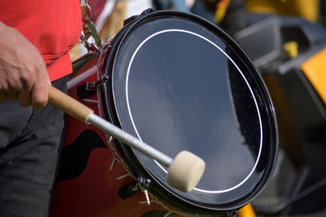 musician plays the kettledrum in a corps of drums, motion blur