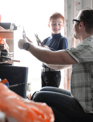 father and son work together in the home workshop