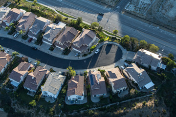 Aerial late afternoon view of suburban San Fernando Valley cul-de-sac street in Los Angeles, California.