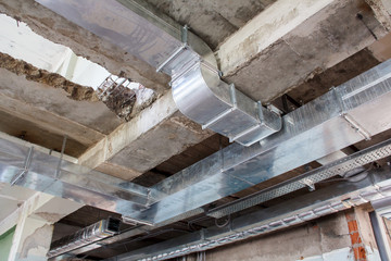 Installation of ventilation ducts during the construction of a new building. Necessary equipment for mounting a ventilation system at a construction site