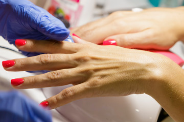 Obraz na płótnie Canvas Female hand with manicure in the salon.