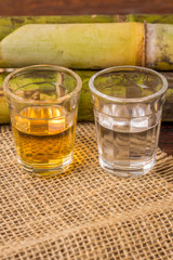 Cachaça is the name of a typical alcoholic drink produced in Brazil maked with sugarcane. Traditional drink from Brazil on wooden table
