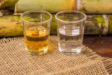 Cachaça is the name of a typical alcoholic drink produced in Brazil maked with sugarcane. Traditional drink from Brazil on wooden table