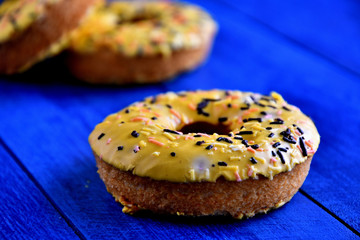 Appetizing donuts on a blue background in the kitchen.