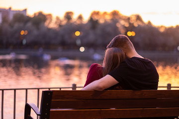 In love with a couple on the shore of the lake on a summer day