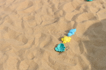 plastic playing things on sand in a sunny day