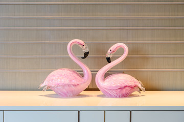 pair of flamingoes inside a living room