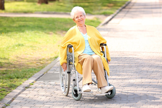 Senior woman in wheelchair at park on sunny day