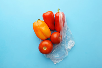 Recycling and environment concept: fresh food in plastic package. Bunch of wrapped bell peppers.