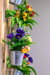 Artificial flowers in pots with interior walls.