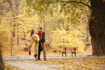 couple on autumn walk outdoors. Two lovers in autumn park. Love and tender touch. Gentle hugs