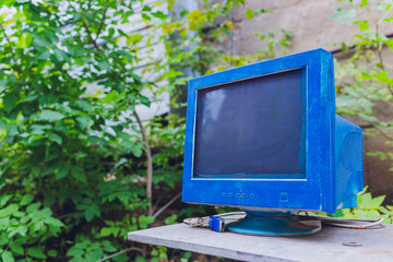 pile of old unused computers and vintage CRT monitors.