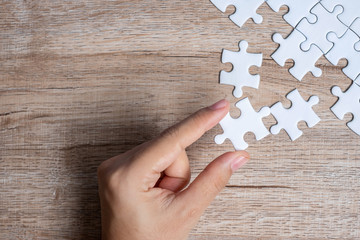 Businessman hand connecting  puzzle piece. Business solutions, mission target, successful, goals, cooperation, partnership and strategy concept