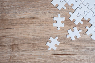 puzzle pieces on wood table background. Business solutions, mission target, successful, goals, cooperation, partnership and strategy concept