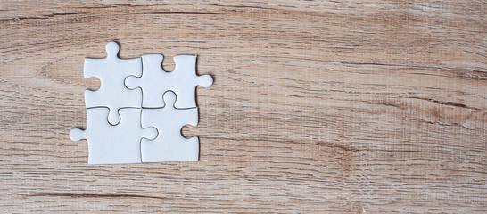 puzzle pieces on wood table background. Business solutions, mission target, successful, goals, cooperation, partnership and strategy concept