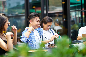 young asian adults relaxing in coffee shop