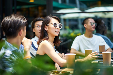 young asian adults relaxing in coffee shop