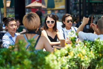 young asian adults relaxing in coffee shop