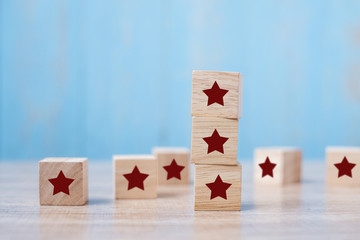 wooden blocks with the star symbol. Customer reviews, feedback, rating, ranking and service concept.