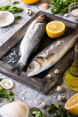Fresh branzino fish with parsley, lemon and pink Himalayan salt
