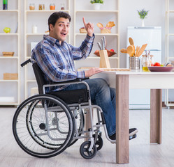 Disabled young man husband working in kitchen